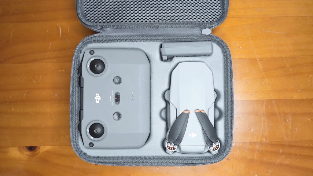 The DJI Mini 4k Camera Drone and accessories in a case