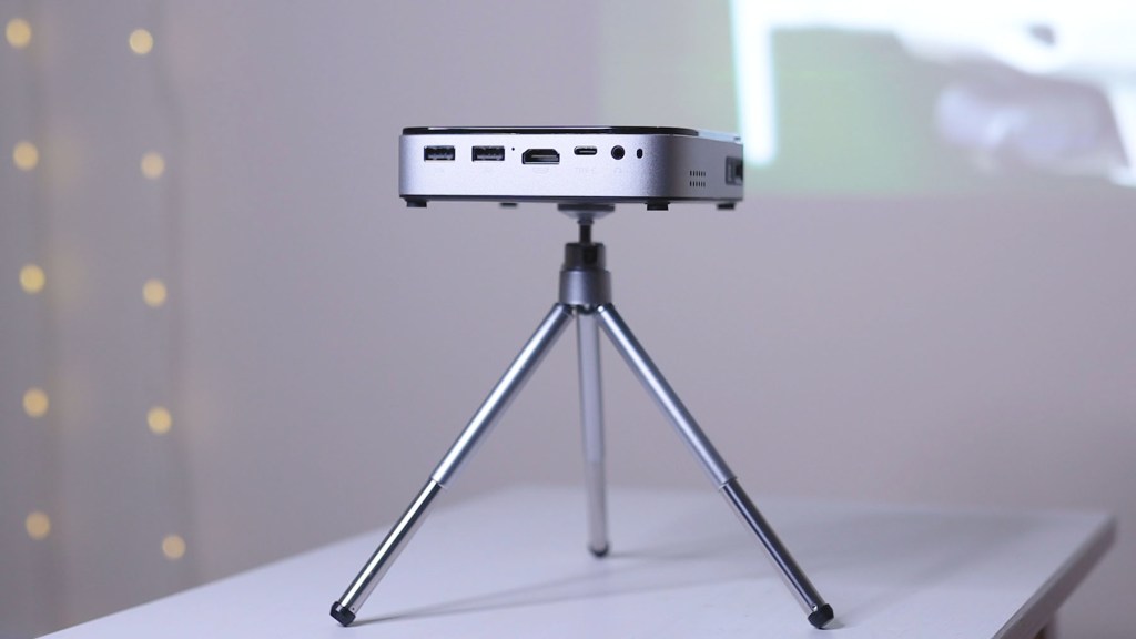 Wimius Q3 Projector on the included mini tripod with extendable legs