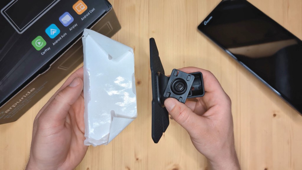 Sticky pad mount included with the Carpuride W903