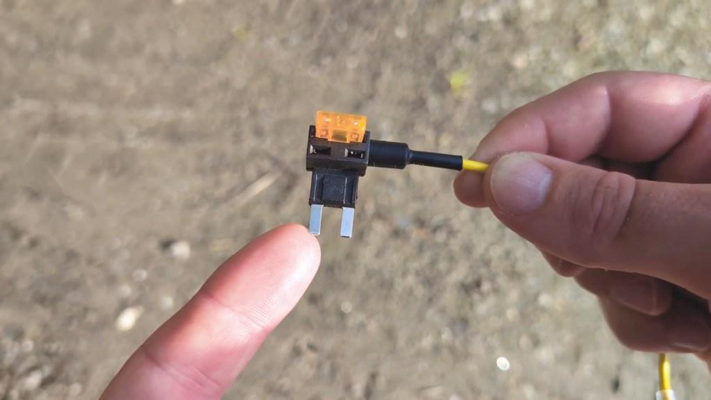 Voltage flows in though this fuse tap prong